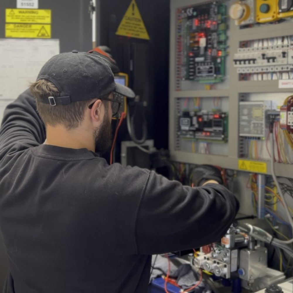 Forge Lifts engineer working on a lift control system